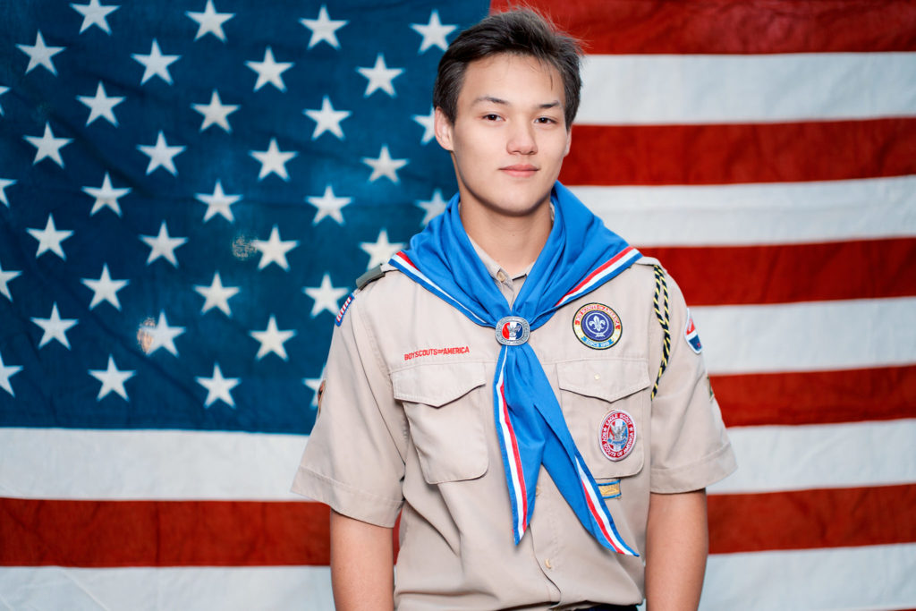 Logan Senior Portrait with US flag in the background